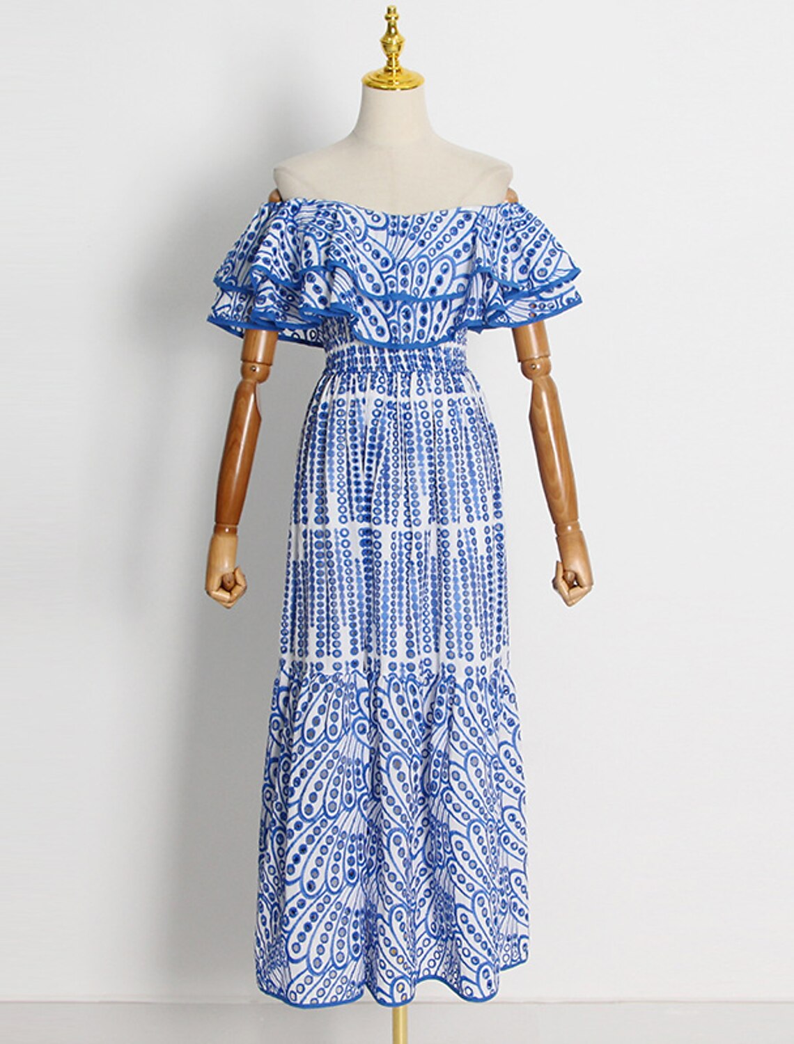Side view of an embroidered A-line dress with short off-shoulder sleeves.