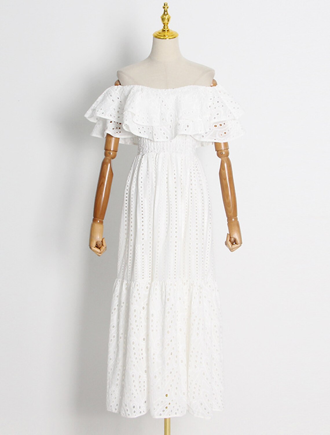 Full length view of a woman in a flowing A-line dress, suitable for wedding guests.