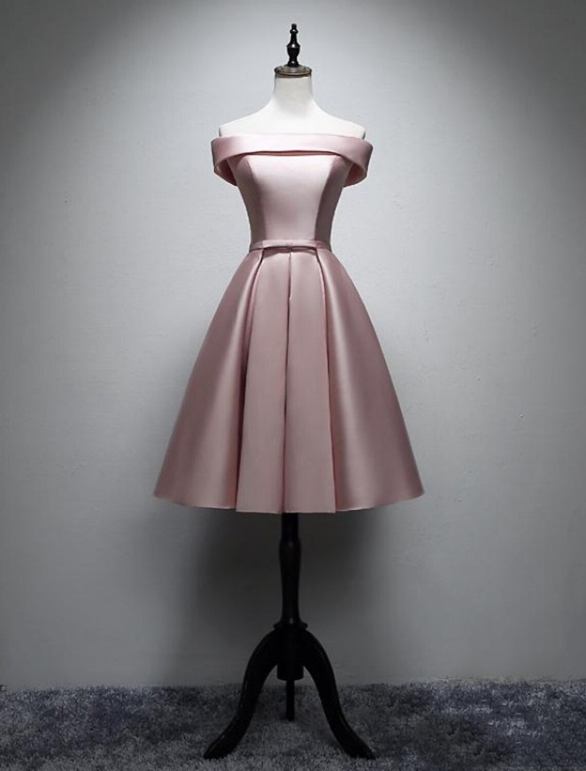 Close-up of satin fabric and bow detail on bridesmaid dress.