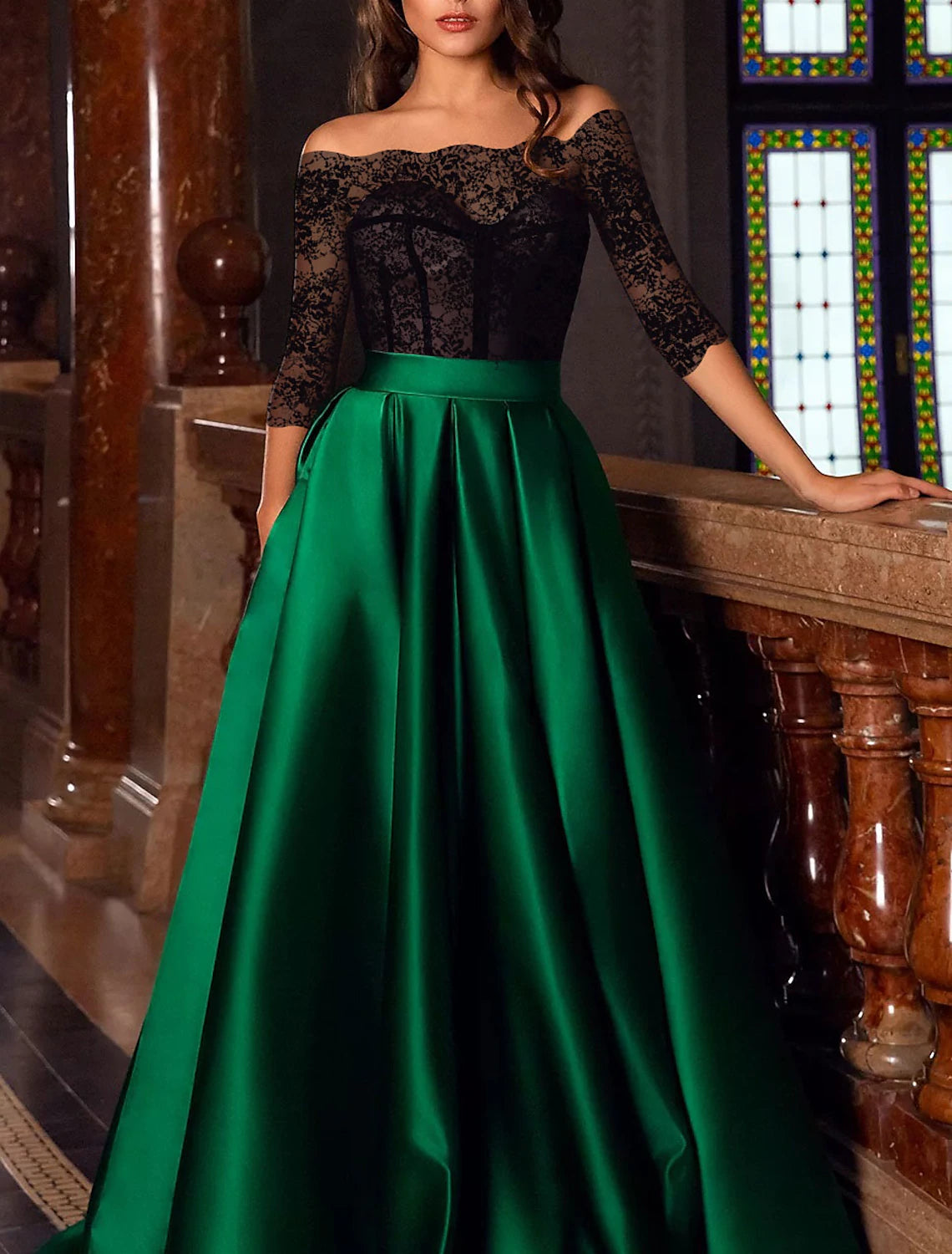 Detail of the 3/4 length sleeve and luxurious satin fabric of the gown.