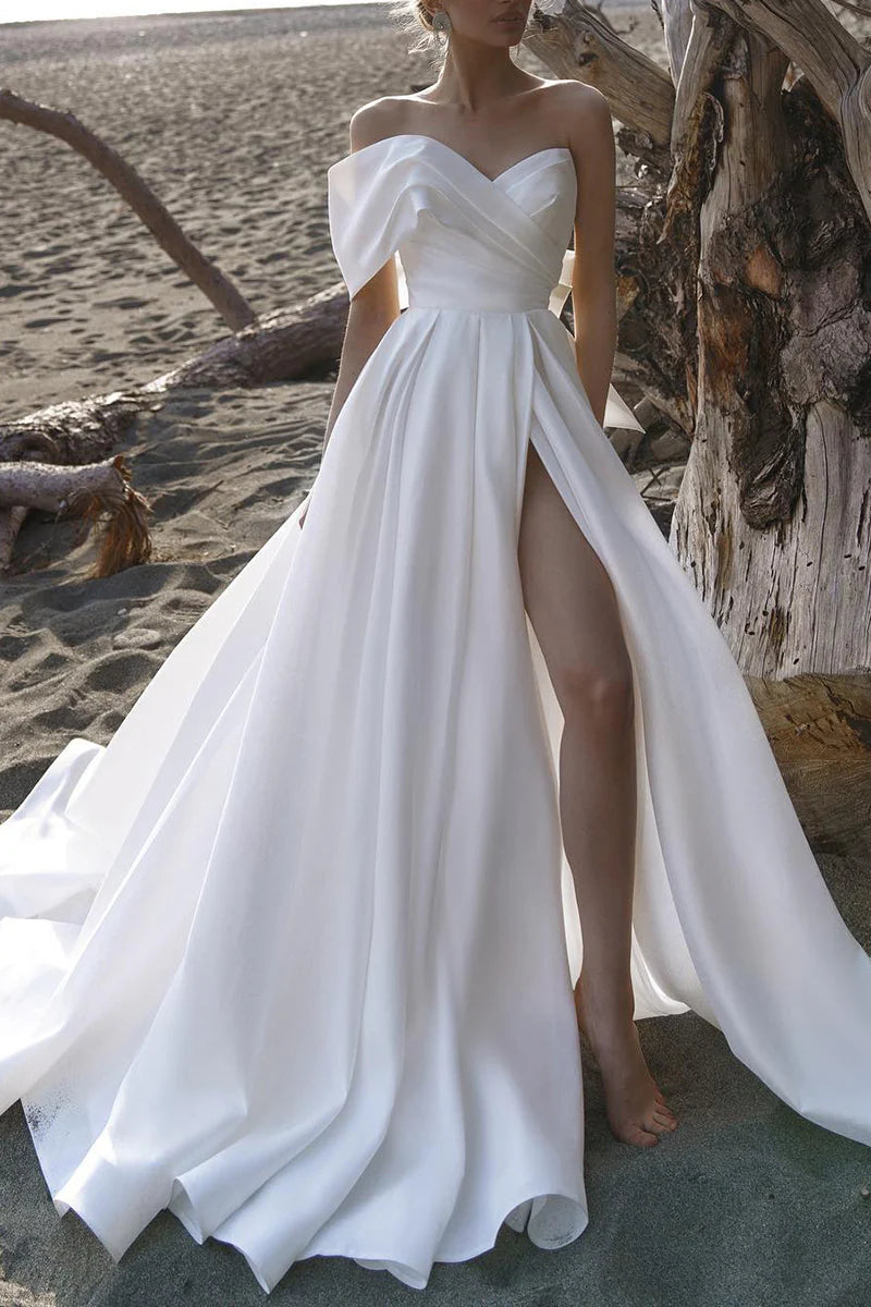 Model wearing an elegant A-line off-shoulder satin pleated wedding dress.