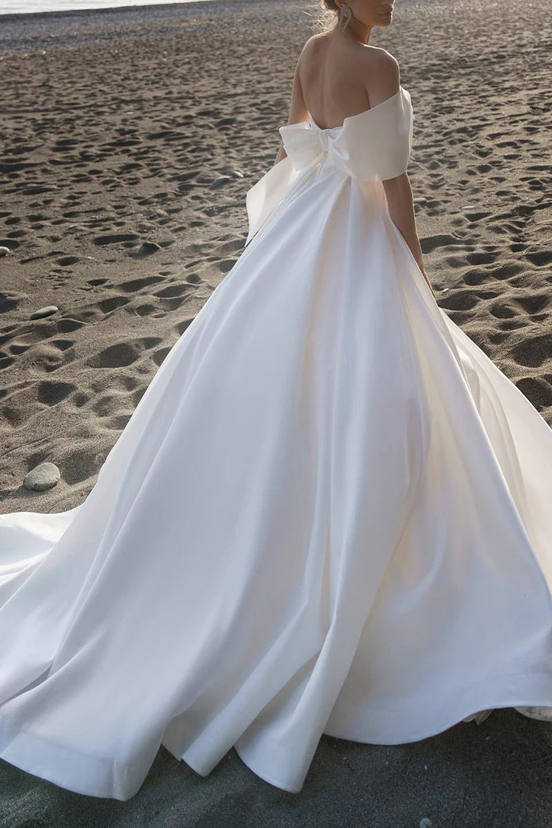 Back view of the A-line satin wedding dress with pleated details.
