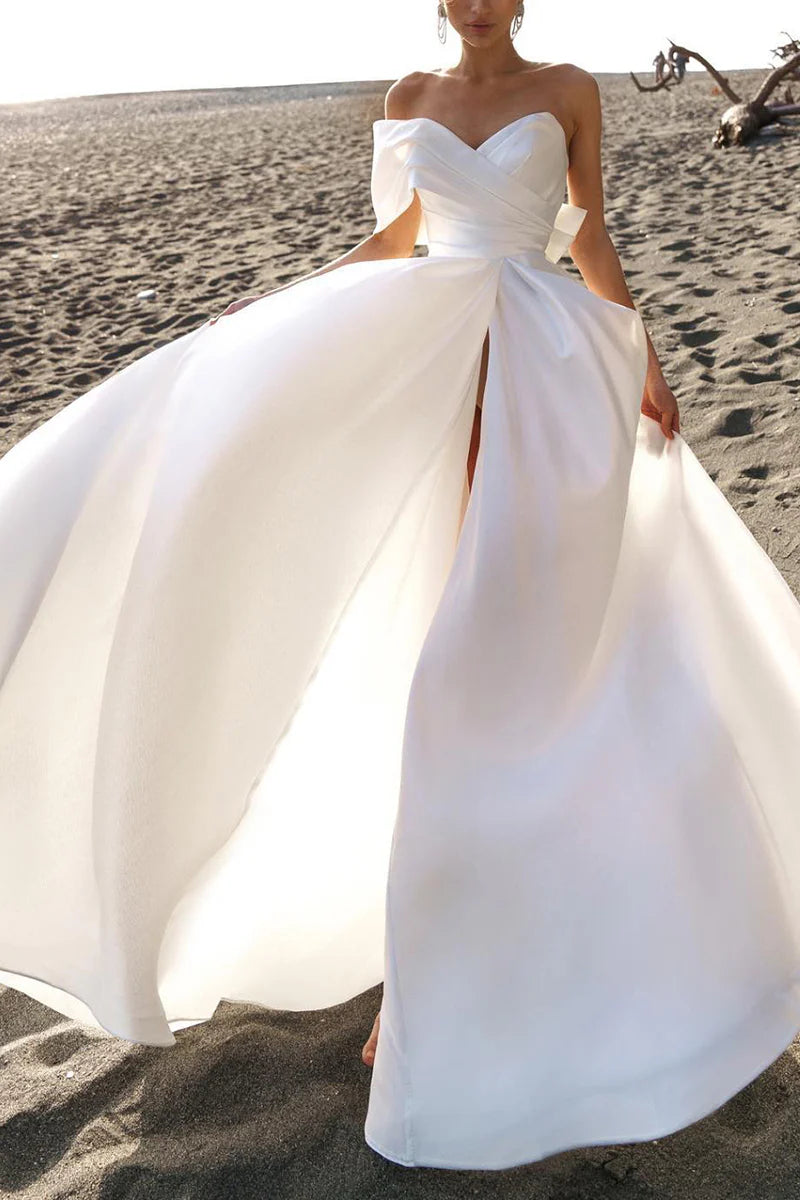Side view of the simple A-line off-shoulder bridal gown.