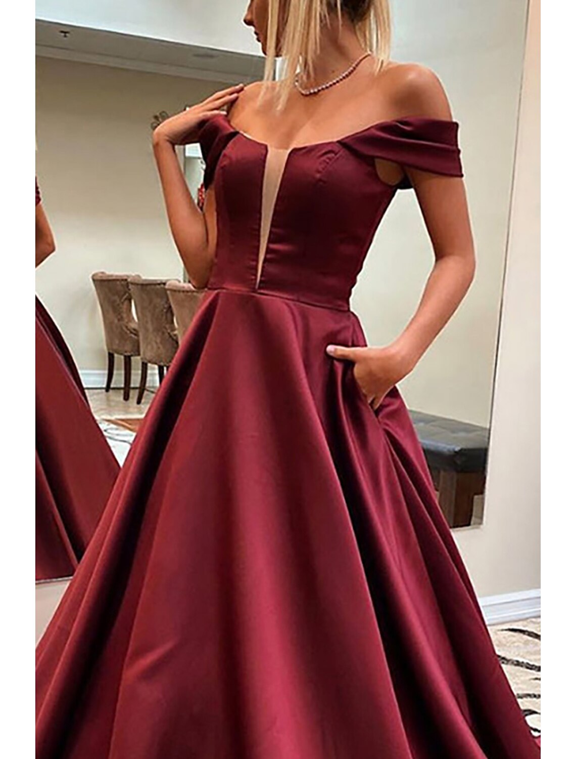 Side view of the A-line off-shoulder satin prom dress.