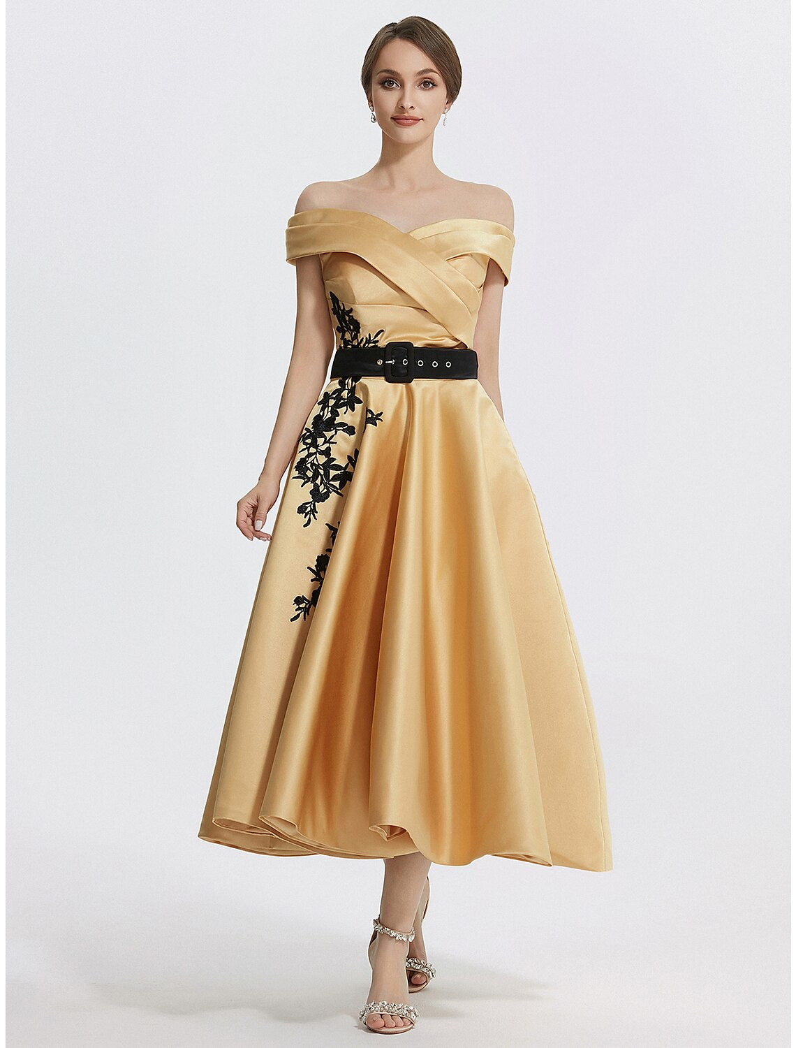 Full length view of the A-line off-shoulder tea length dress.