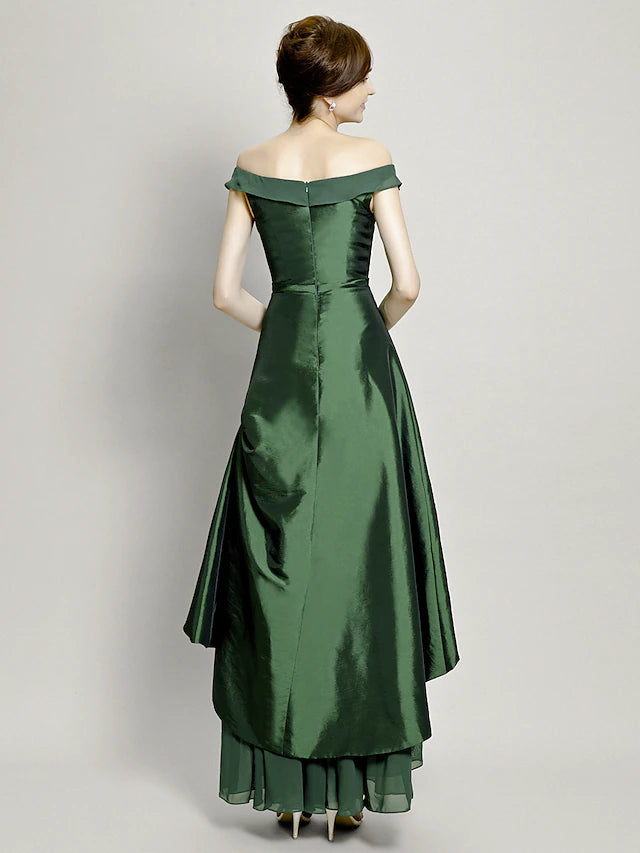Full length view of the asymmetrical mother of the bride gown with bow accents.