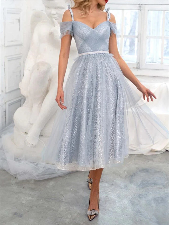 Model wearing an elegant A-Line off-shoulder knee-length cocktail dress.