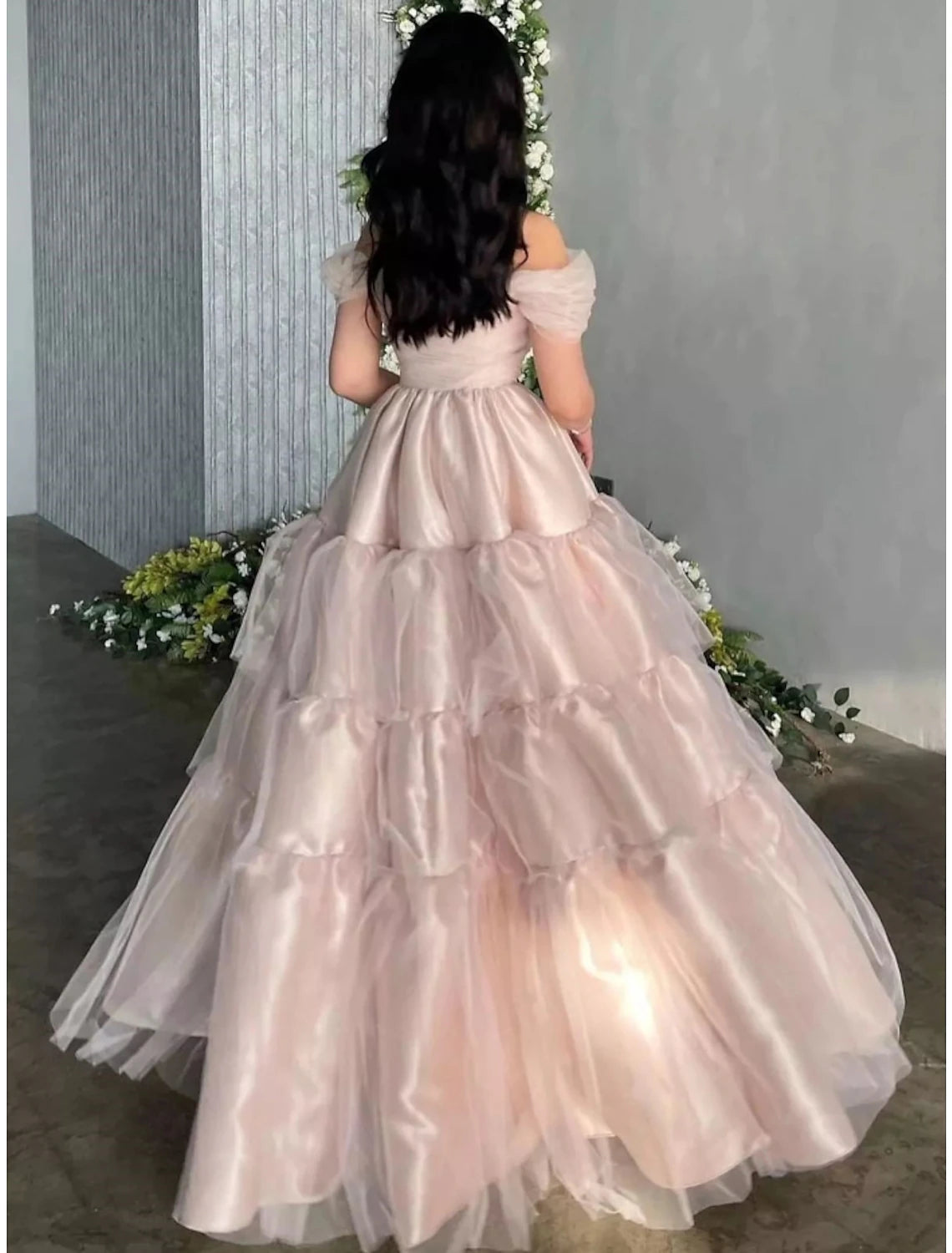 Side view of the A-line off-shoulder dusty blue satin gown, highlighting the flowing skirt.