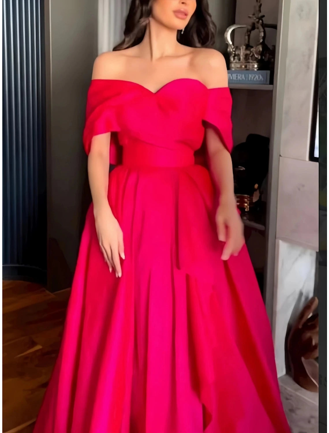 Back view of red A-line off-shoulder satin evening gown.
