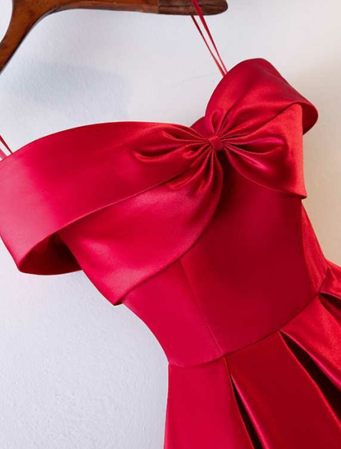 Close-up of the off-shoulder neckline and ruched detail on the satin prom dress.