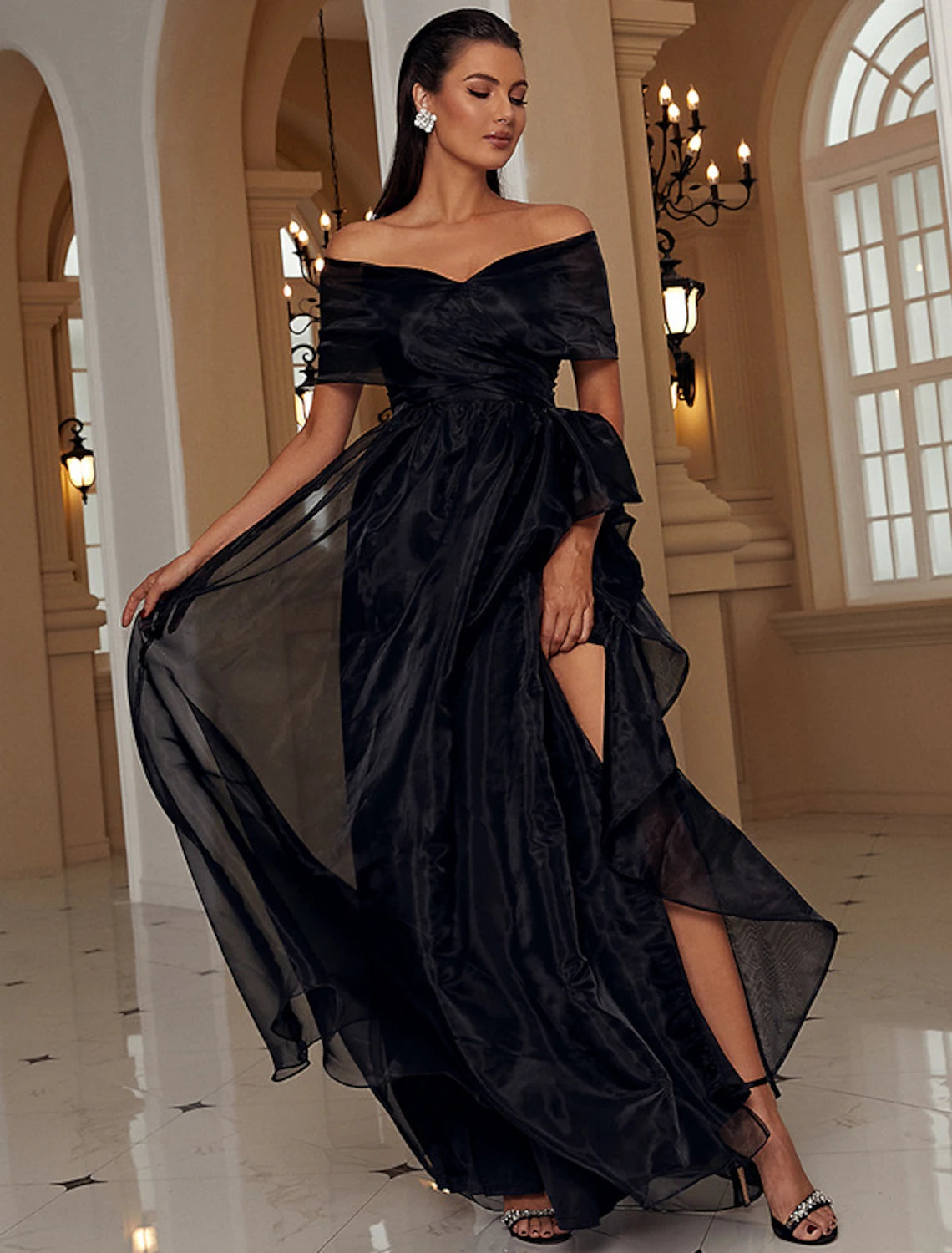 Side view of the A-line off-shoulder formal gown with a thigh-high slit.