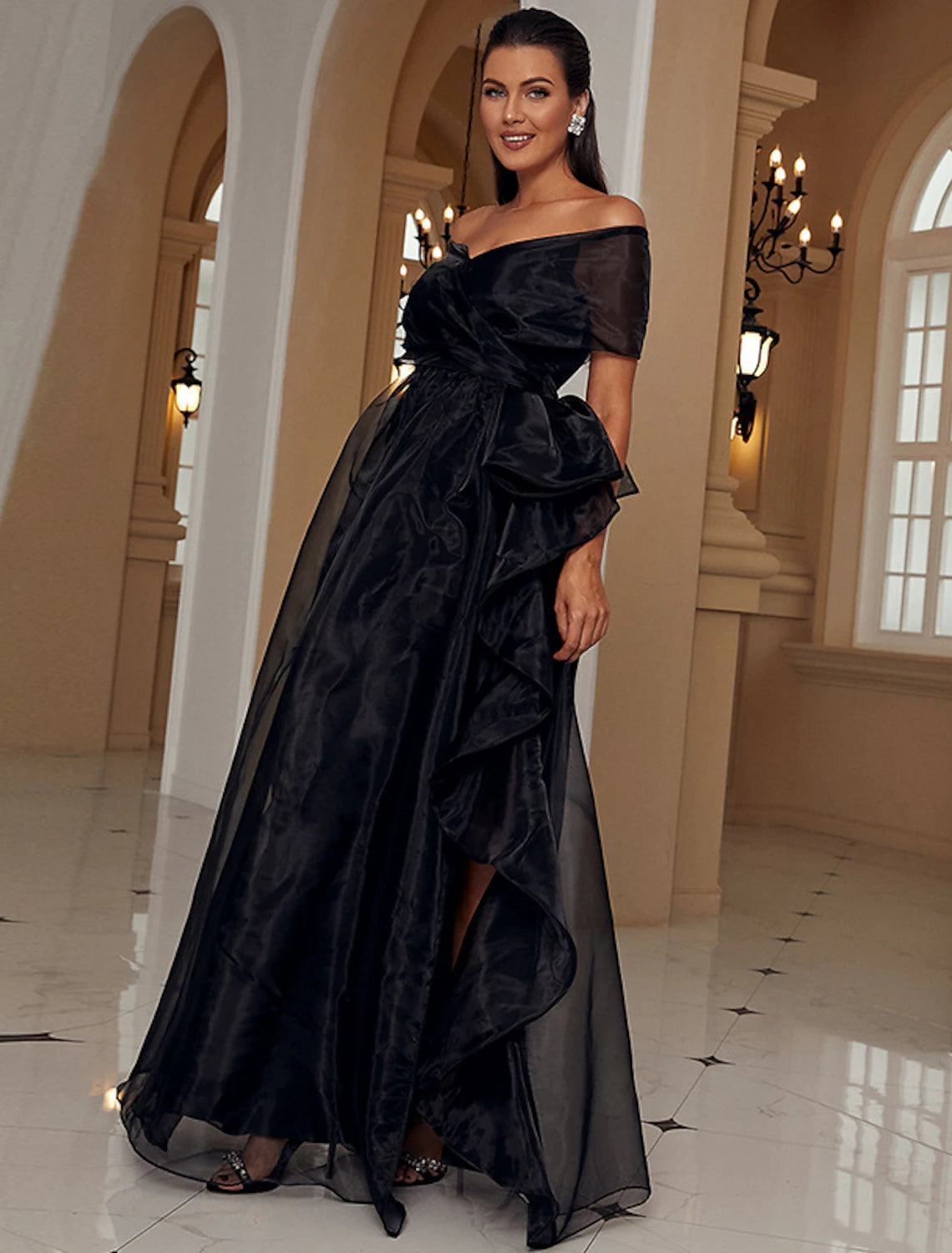 Close-up of ruffled short sleeve and elegant thigh-high slit on the A-line gown.