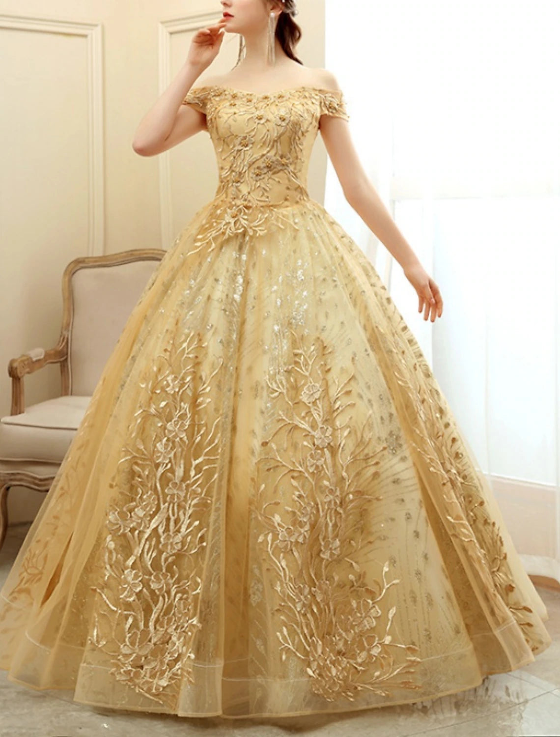 Side view of A-line off-shoulder short sleeve tulle dress.