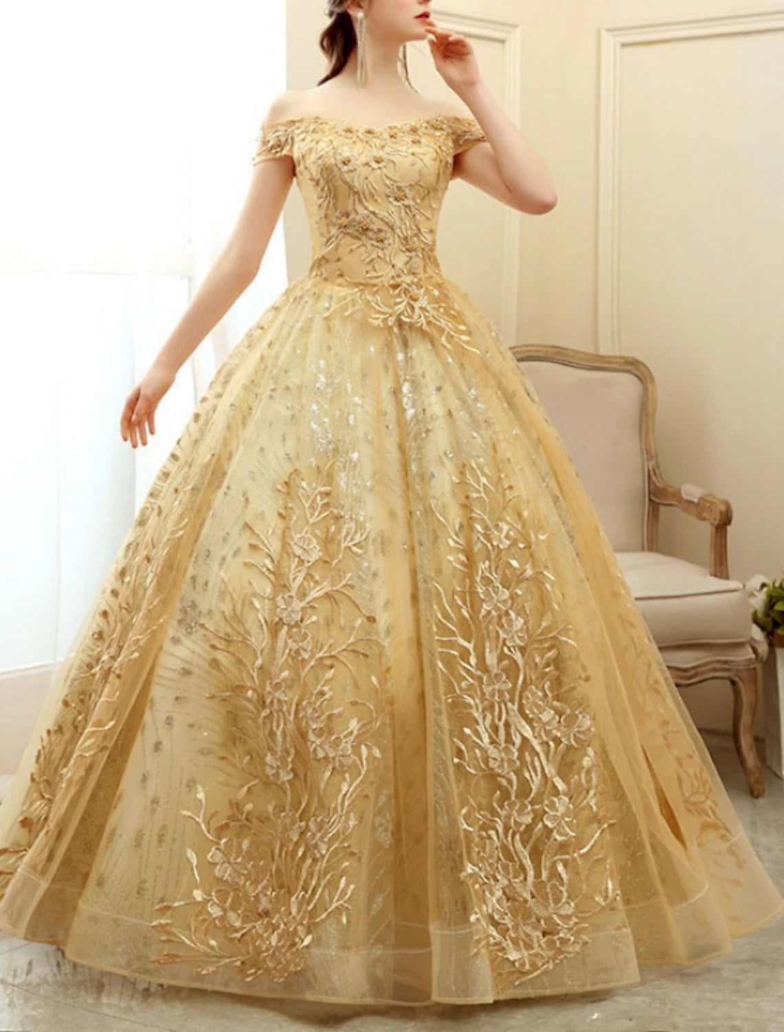 Close-up of off-shoulder neckline and short sleeve on tulle gown.