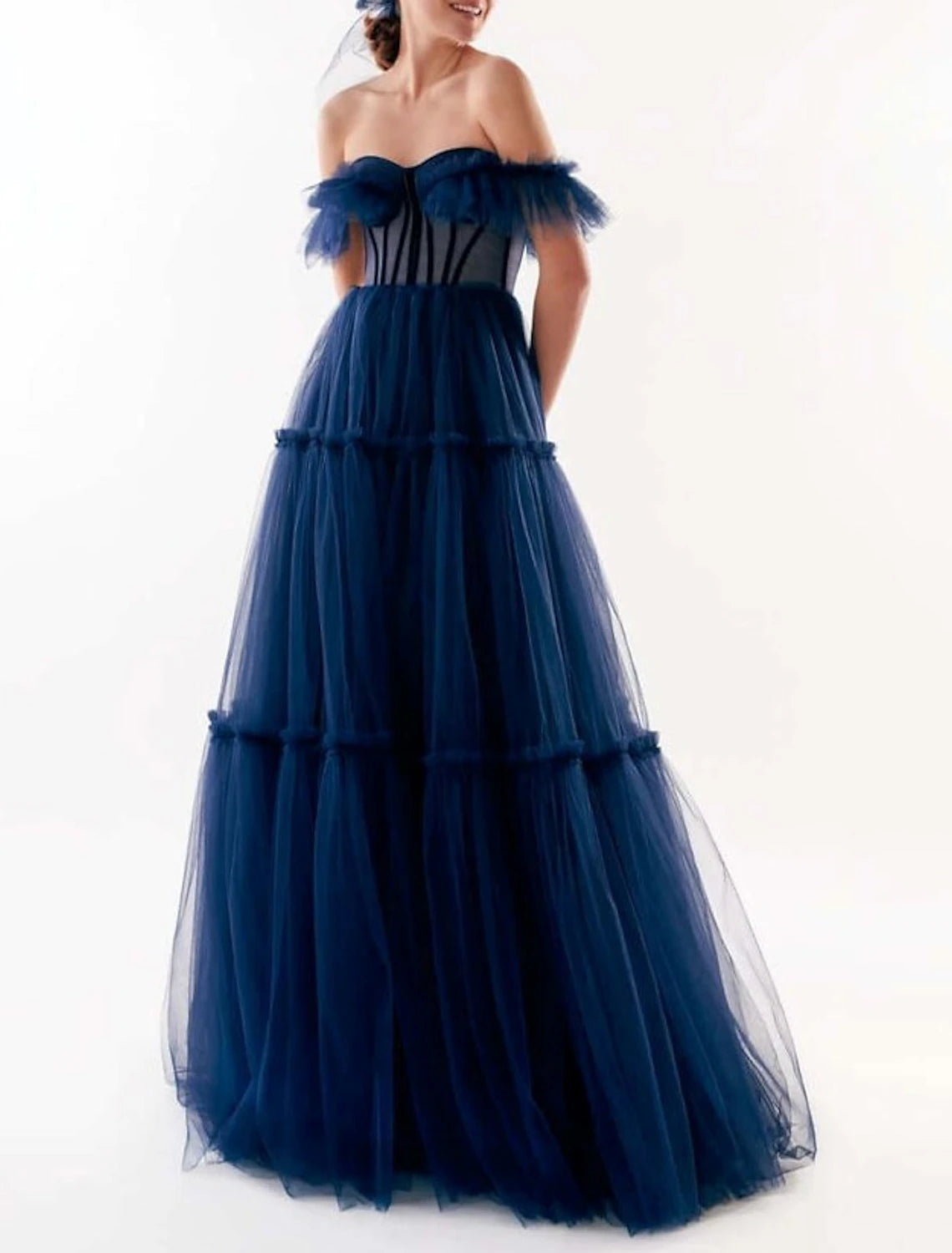 Side view of a model wearing an A-line off-shoulder formal dress.