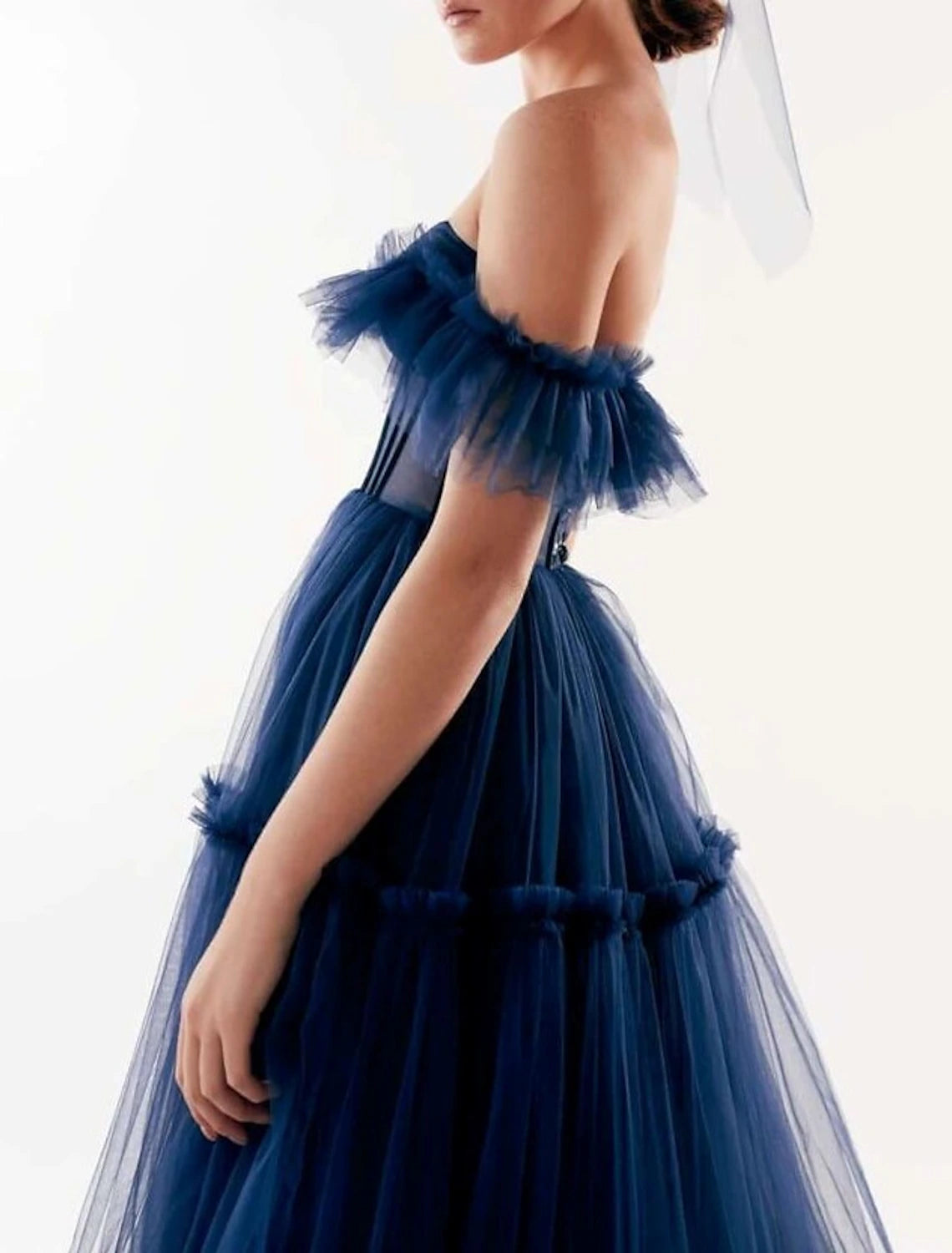 Detail of the pleated and ruffled skirt of the floor-length A-line gown.