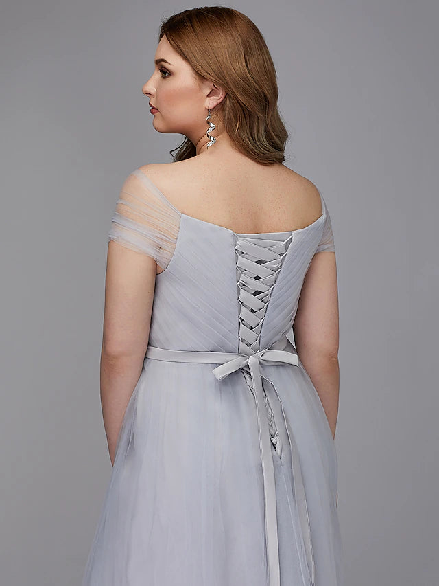 Close-up of the off-shoulder neckline and short sleeves of the elegant tulle dress.