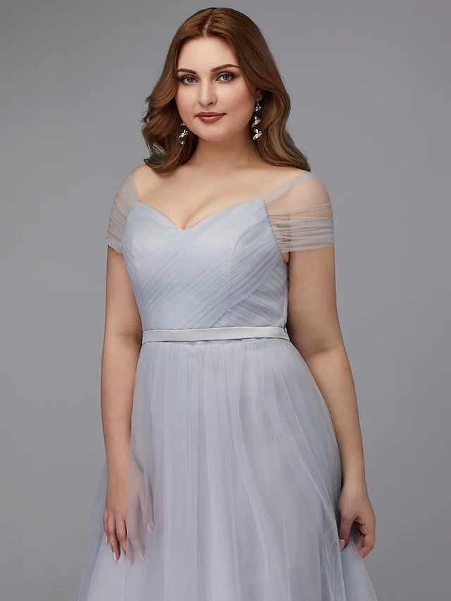 Model posing gracefully in an A-line off-shoulder tea length tulle dress, showing its full silhouette.