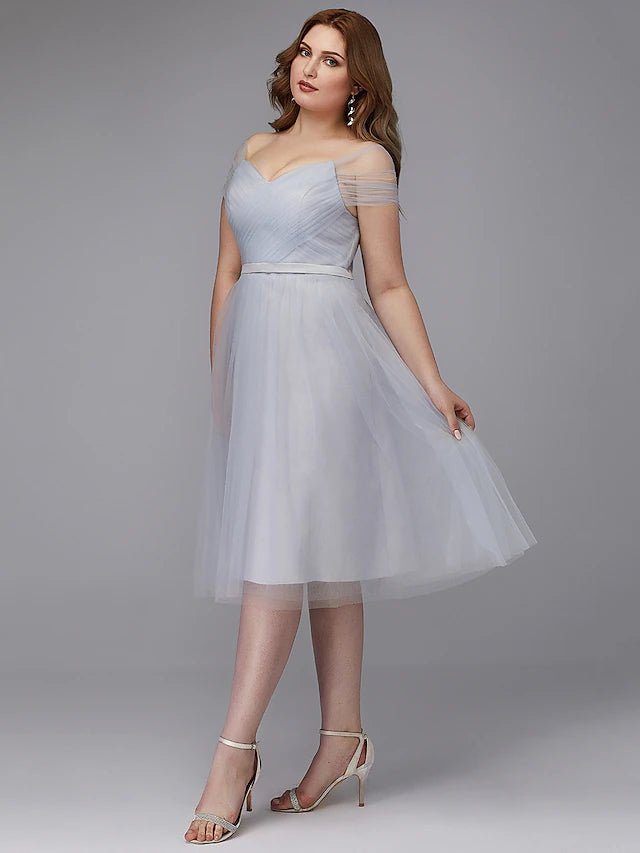 Front view of the elegant A-line off-shoulder tea length tulle dress on a model.