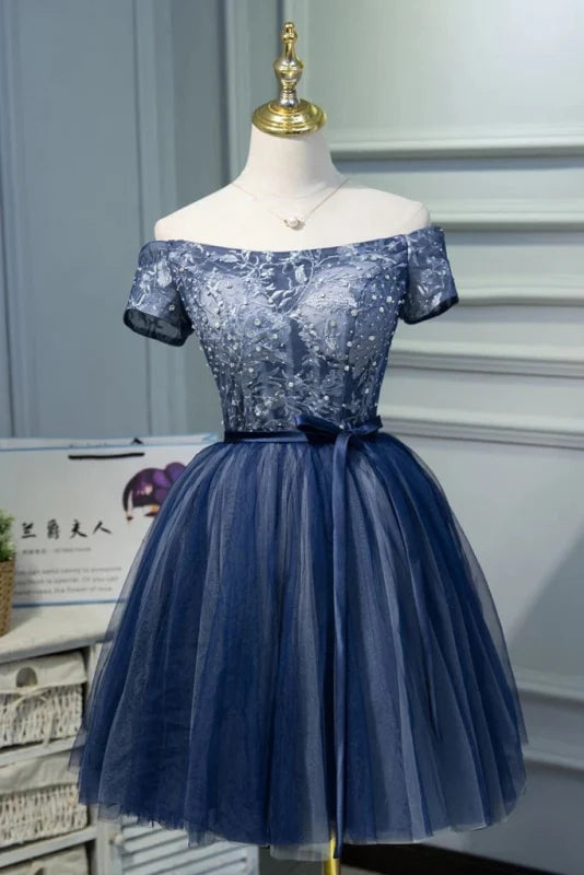 Dusty blue A-line off-shoulder prom dress with tulle and applique details.