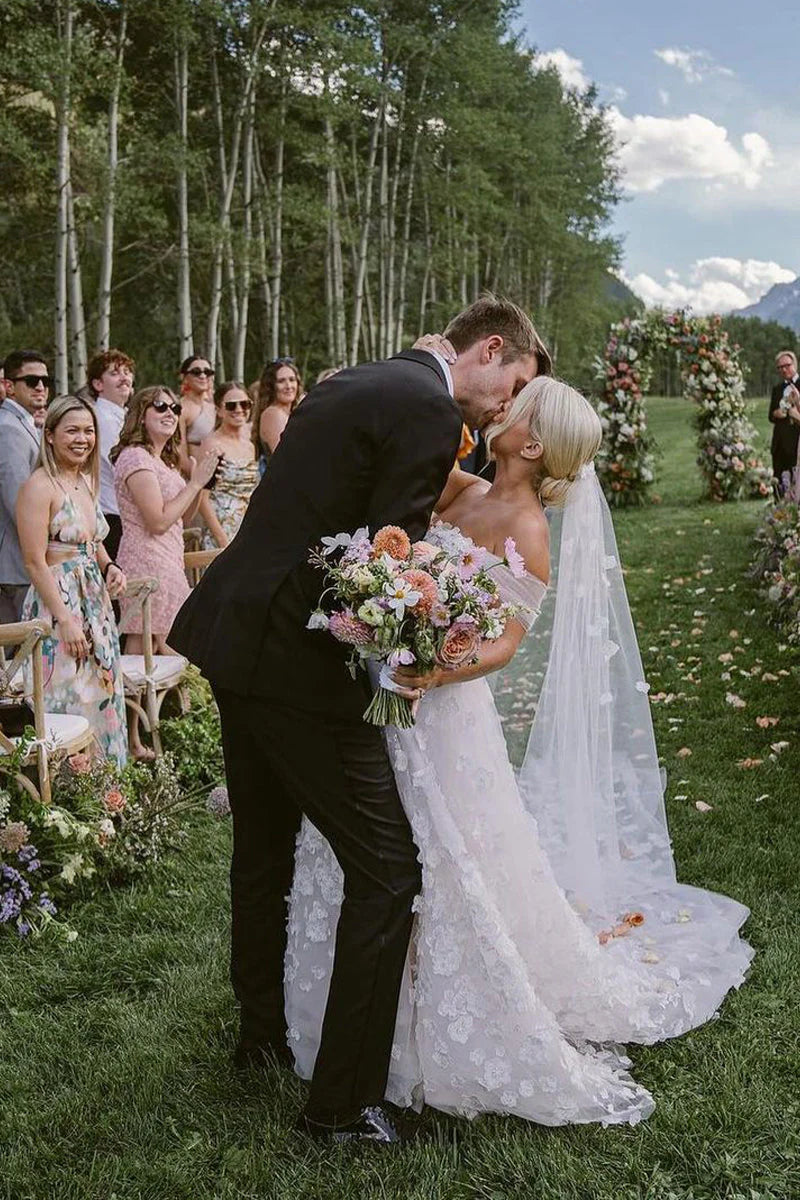 Side profile of the romantic off-shoulder tulle wedding dress.