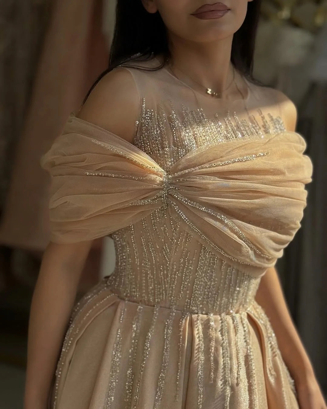 Back view of elegant off-shoulder V-neck prom dress.