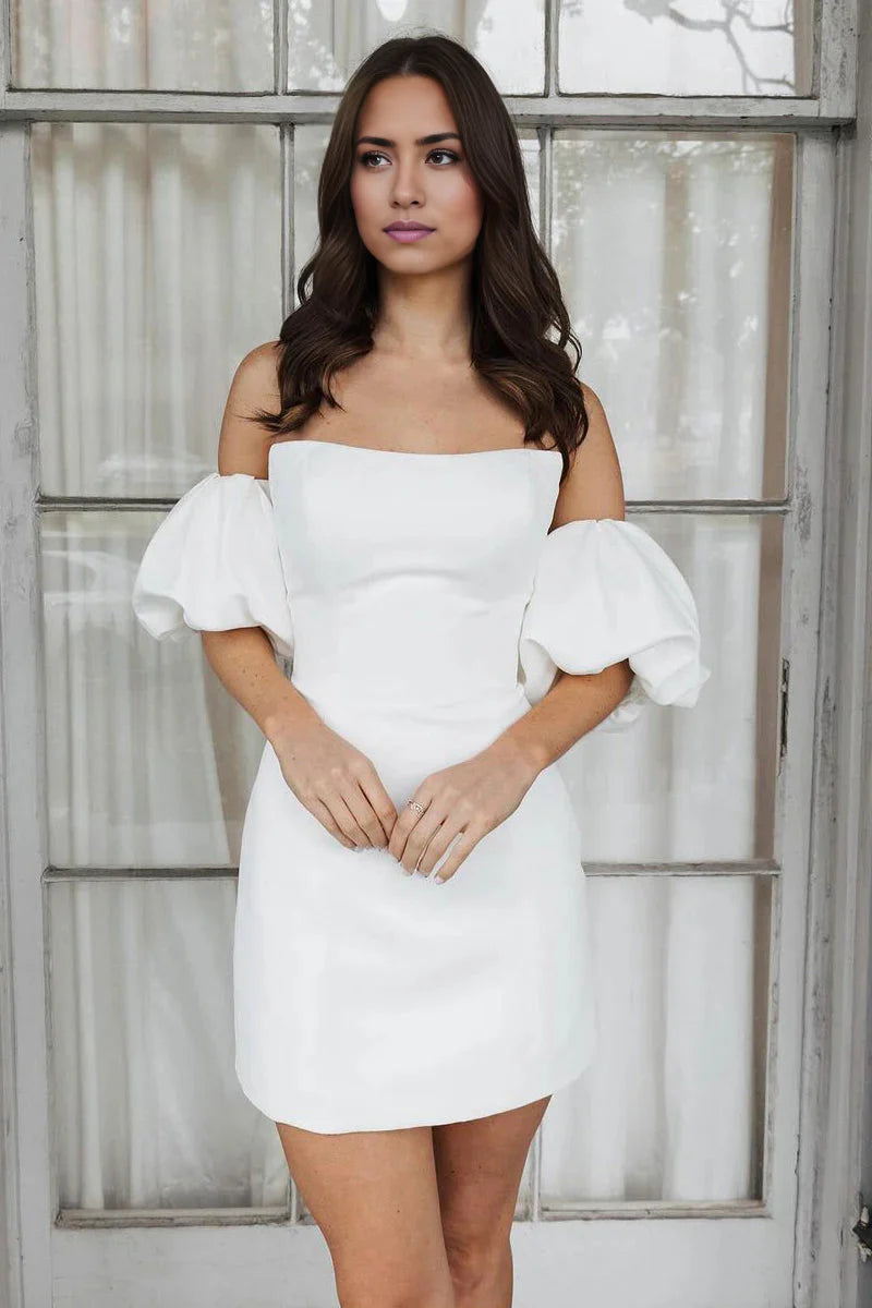 Woman wearing a short off-shoulder satin wedding dress.