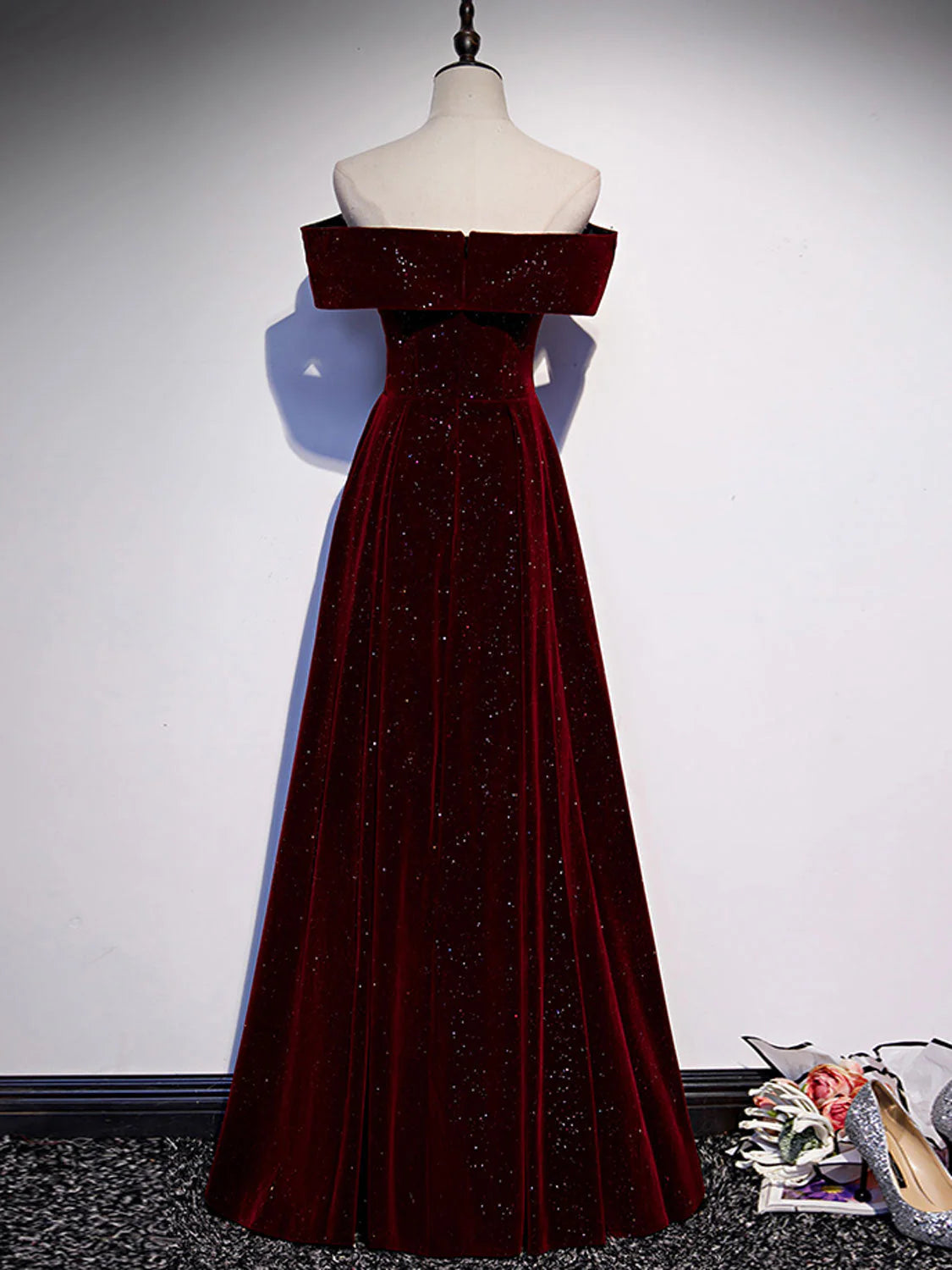Side profile of the A-line off-shoulder velvet long prom dress.