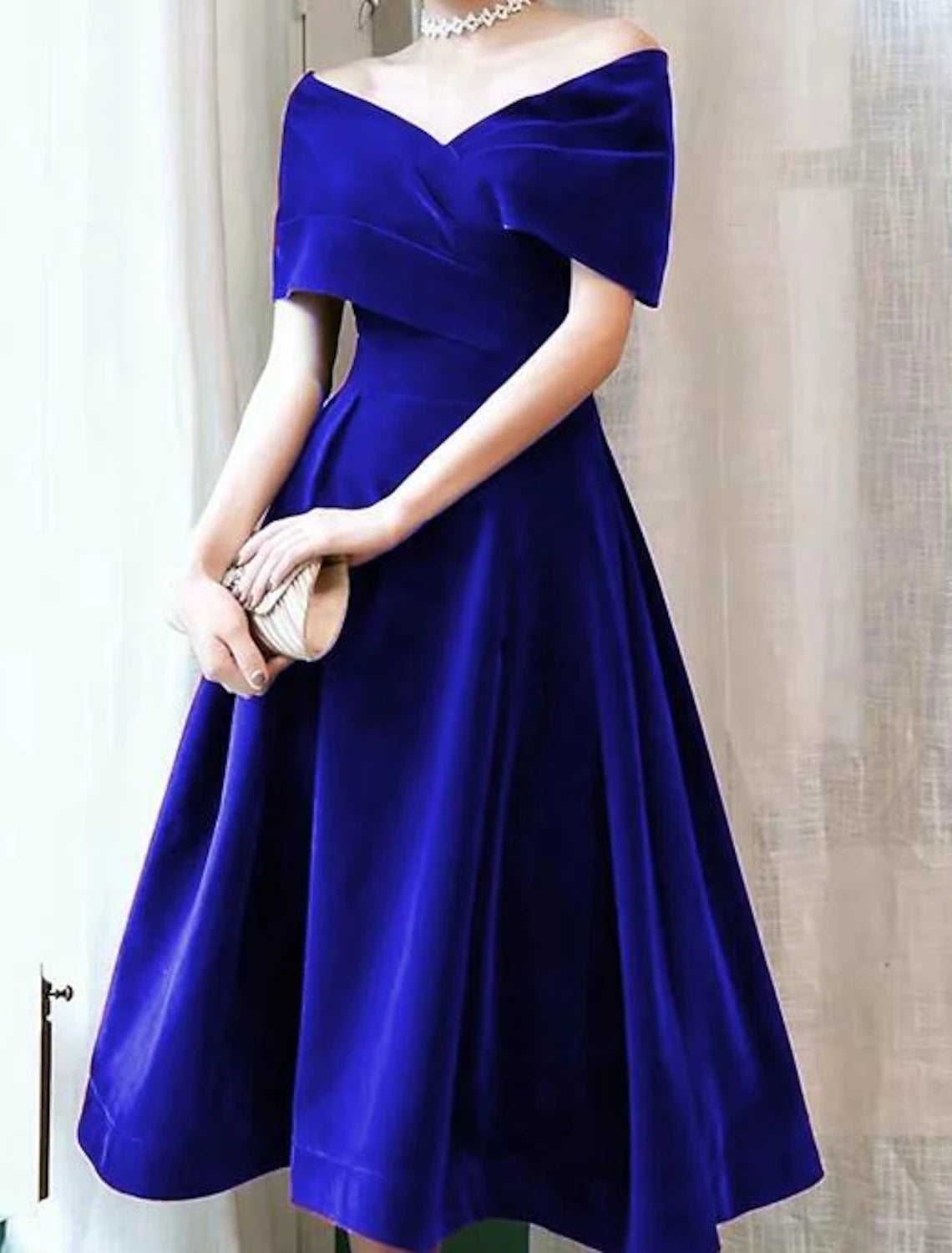 Side view of the A-Line velvet dress, showcasing the knee-length hem.