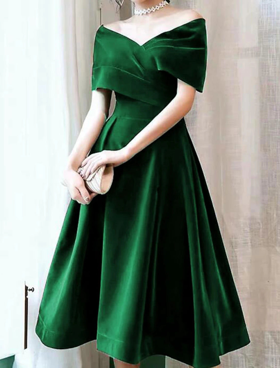 Back view of the elegant off-shoulder velvet dress.