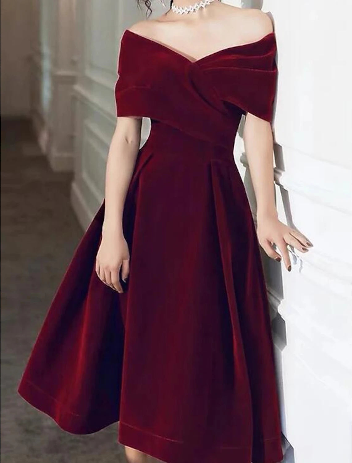 Close-up of the velvet fabric and pleat details on the A-Line dress.