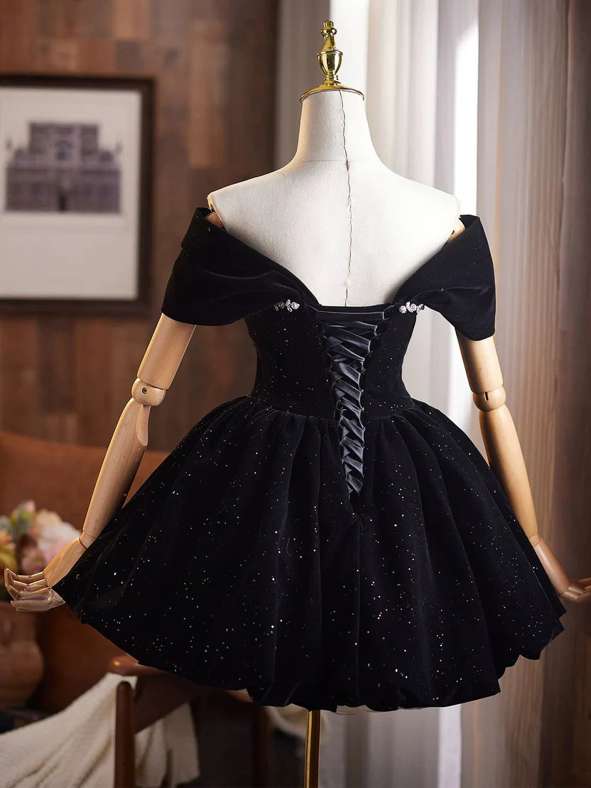 Back view of black velvet homecoming dress featuring corset lace-up detail.