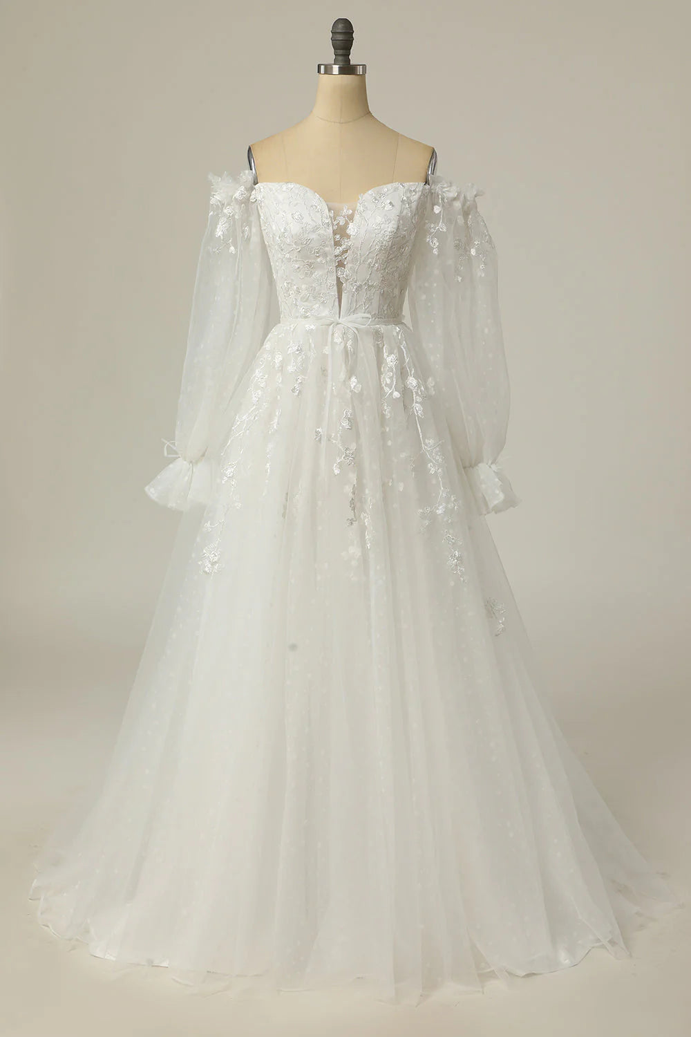 A-line off-shoulder wedding dress with appliques, front view.
