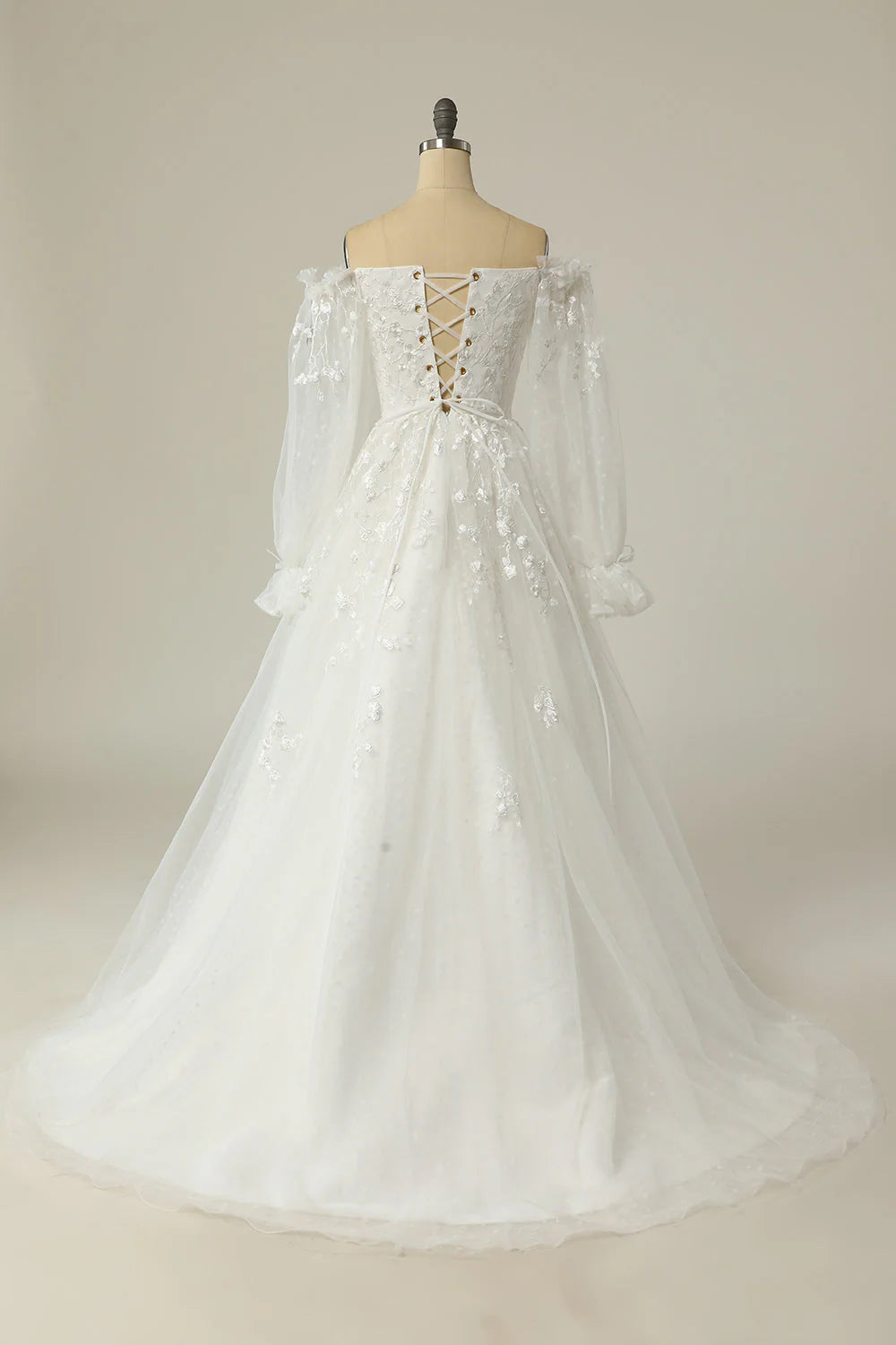 Back view of an A-line off-shoulder wedding dress with appliques.