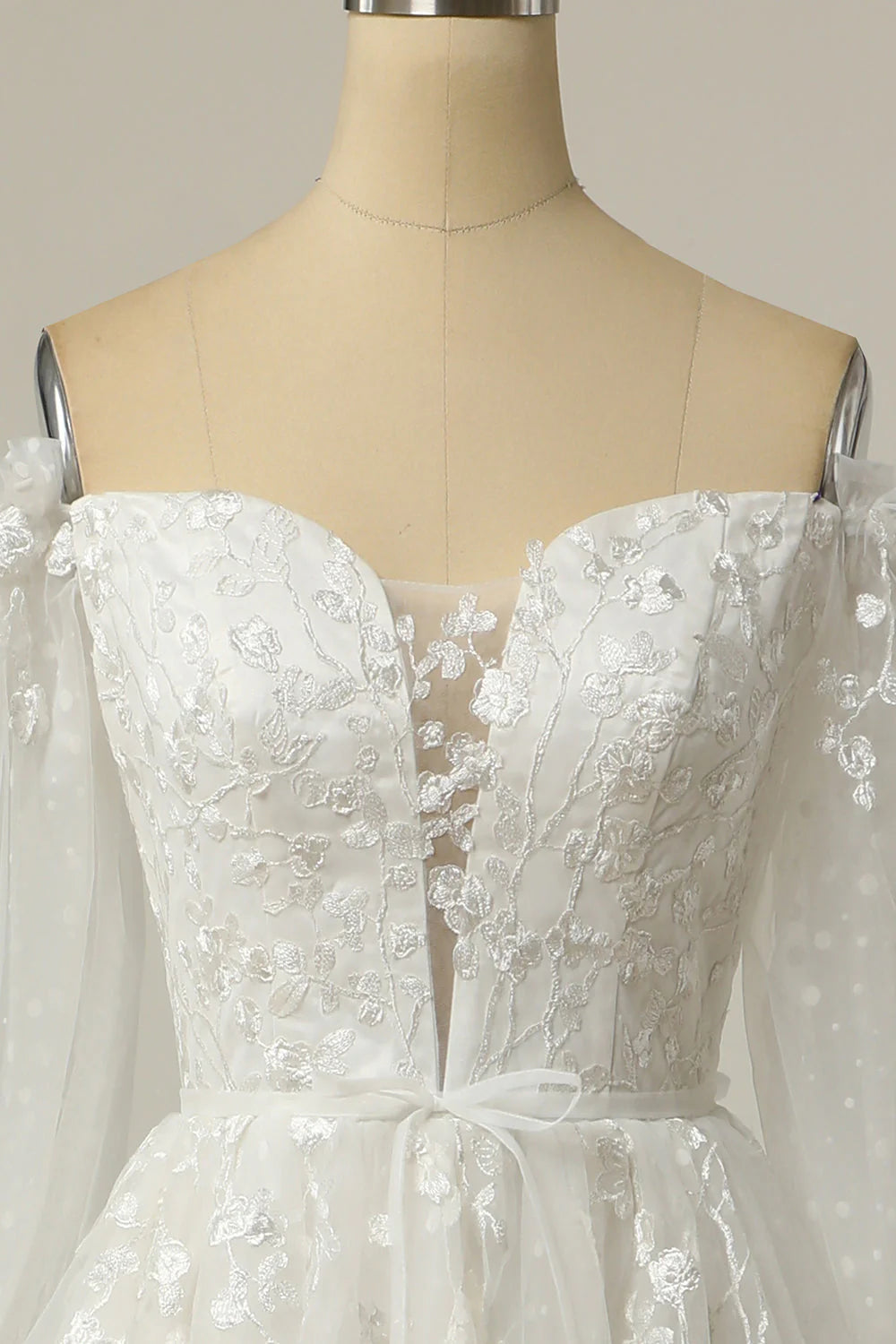 Close-up of delicate appliques on the bodice of a wedding dress.