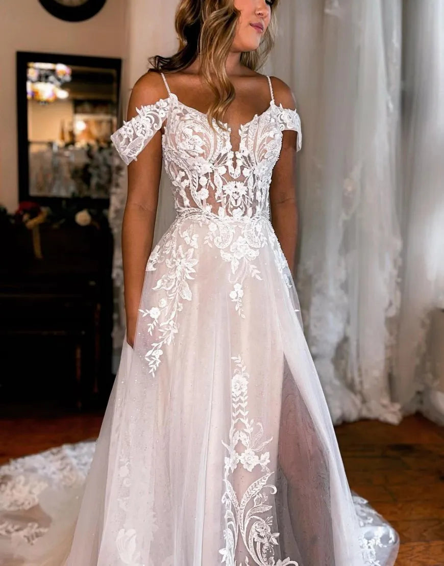 Full view of an A-line off-shoulder wedding dress with intricate appliques and a flowing skirt.