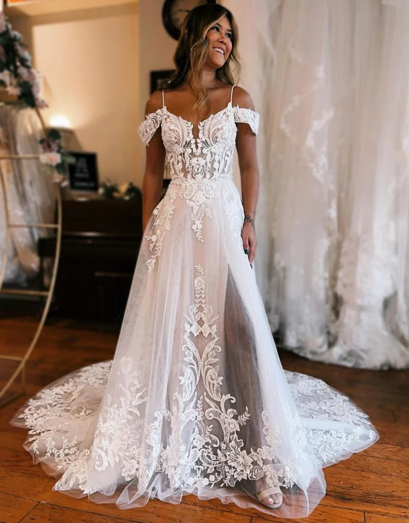Elegant A-line off-shoulder wedding dress with delicate appliques and a stylish leg slit.