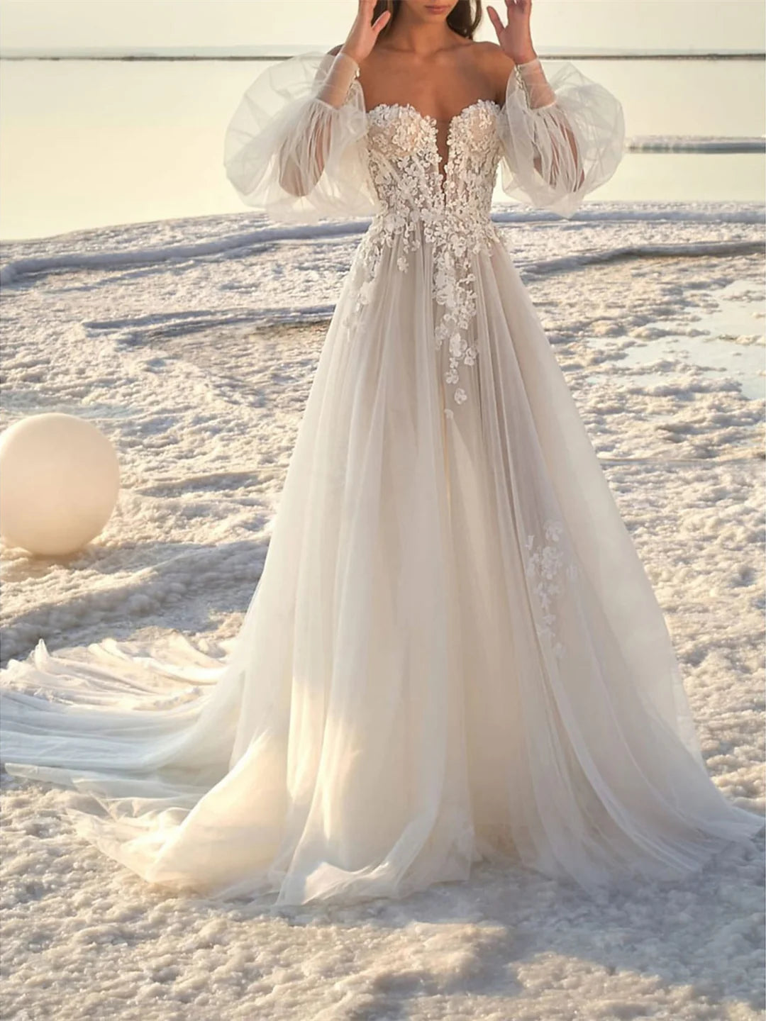 Elegant A-line off-shoulder wedding dress with a court train, front view.