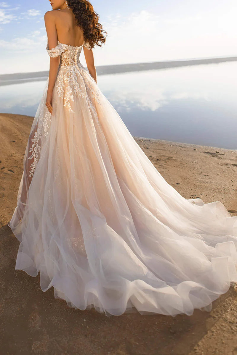 Back view of an A-line off-shoulder wedding dress with delicate lace details.