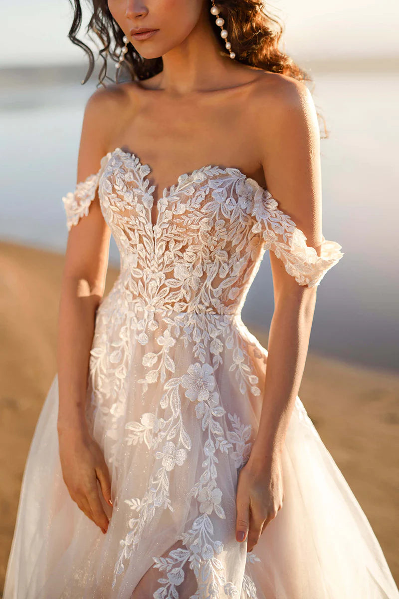 Side profile of an elegant A-line wedding dress featuring lace appliques.