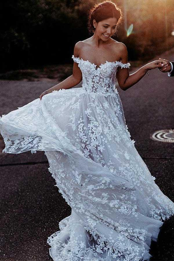 Elegant A-Line off-shoulder white tulle wedding dress with delicate appliques.