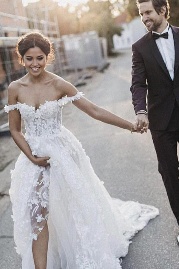 Front view of an A-Line off-shoulder white tulle wedding dress with appliques.