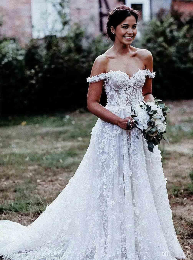 Side view of an A-Line off-shoulder white tulle wedding dress with intricate appliques.