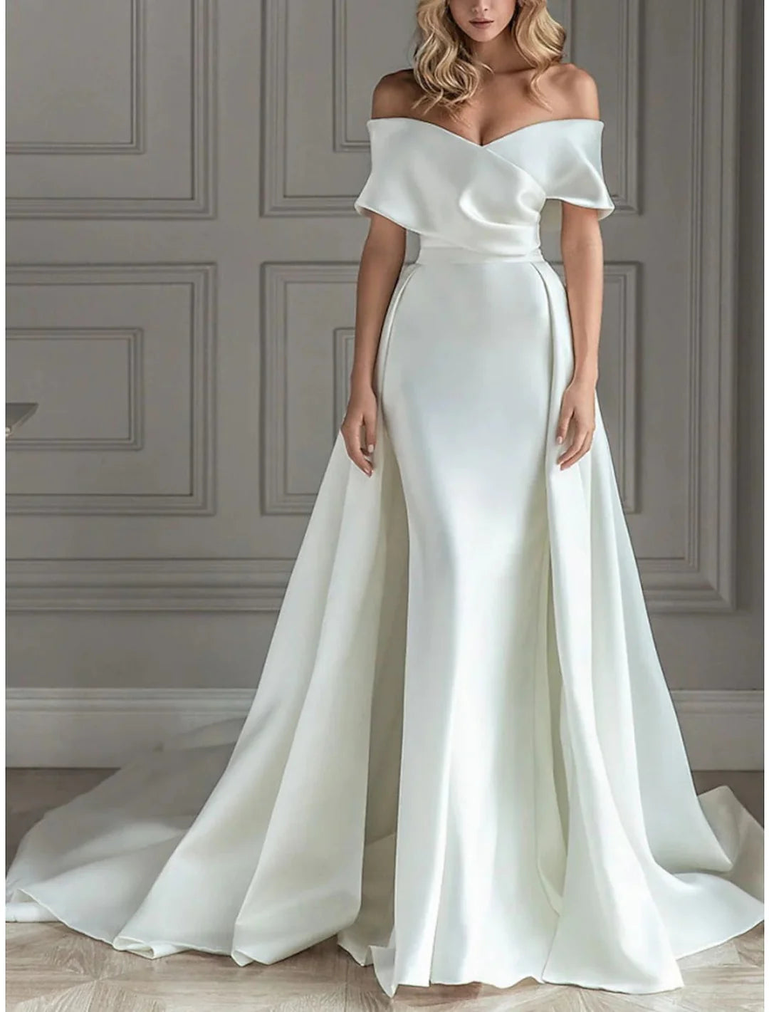 Model wearing an elegant A-line off-the-shoulder floor-length wedding dress, front view.