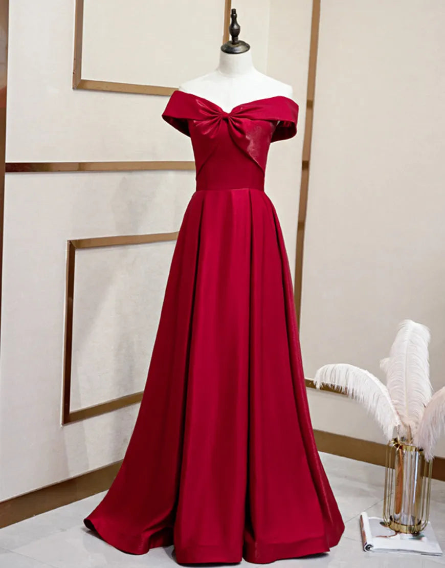 Woman wearing a periwinkle A-line off-the-shoulder prom dress.