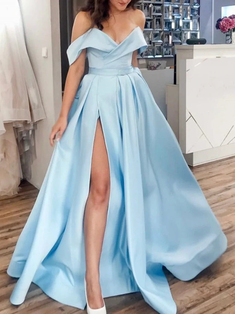 Woman wearing a navy blue off-the-shoulder satin A-line prom dress.