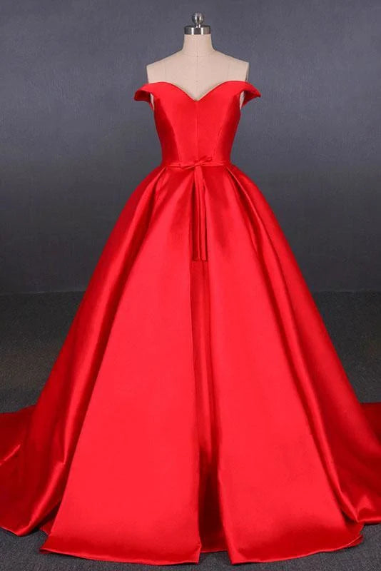 Woman wearing an elegant A-line off-the-shoulder satin maxi prom dress with a matching belt.