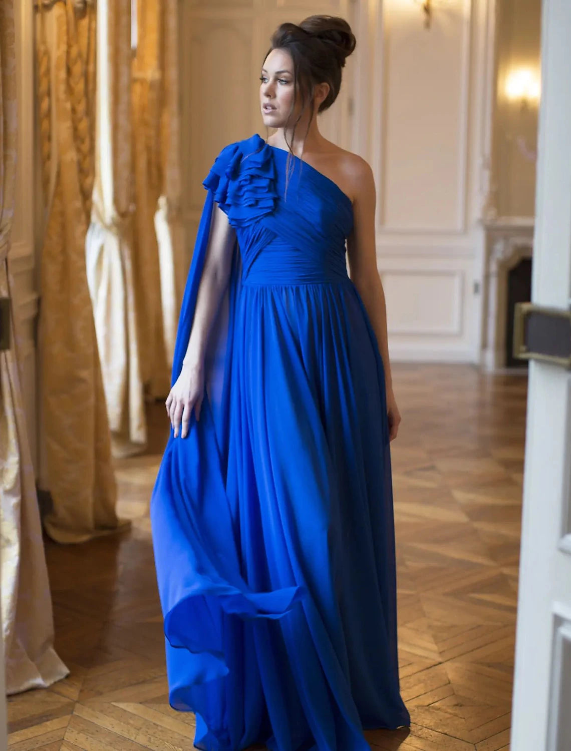 Elegant A-Line one-shoulder chiffon evening gown with pleats and flower detail.