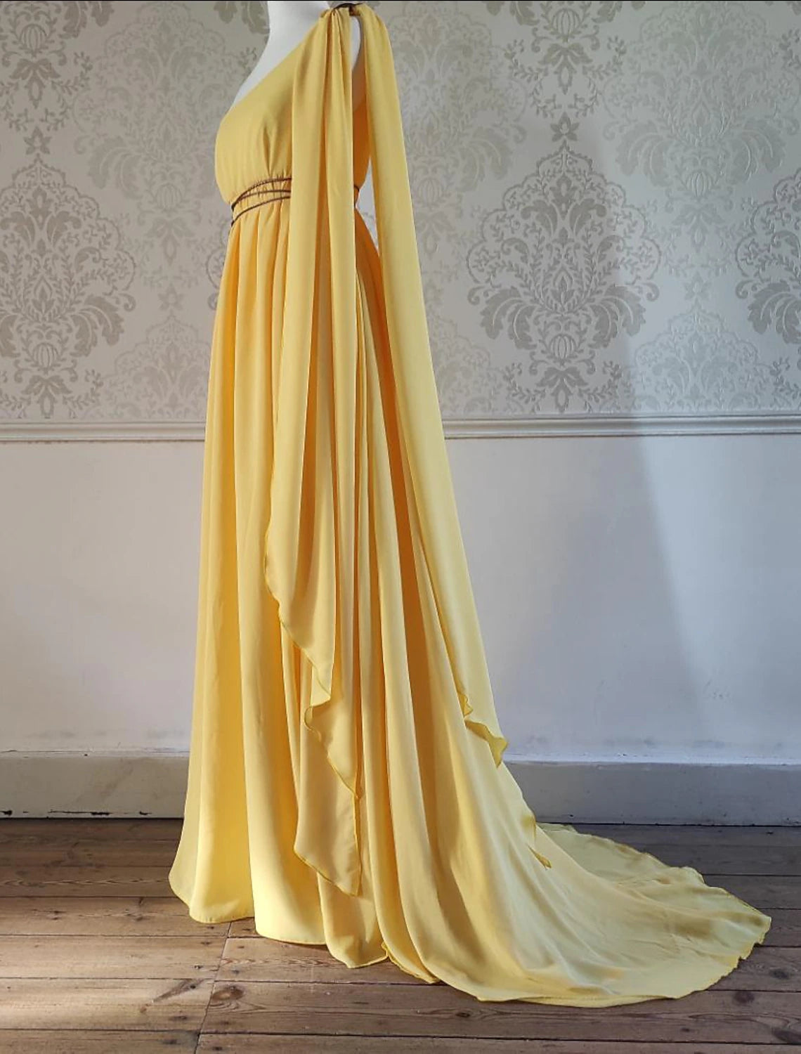 Close-up of the strappy detail on the one-shoulder chiffon dress.