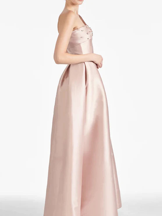 Side profile of the sophisticated floor-length dress.